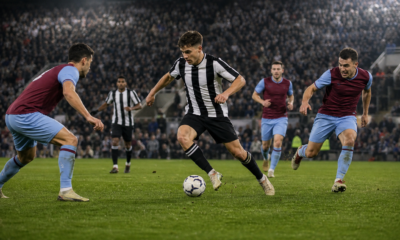 Football forward dribbling under pressure in a stadium, illustrating Newcastle and West Ham match analysis