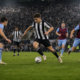Football forward dribbling under pressure in a stadium, illustrating Newcastle and West Ham match analysis